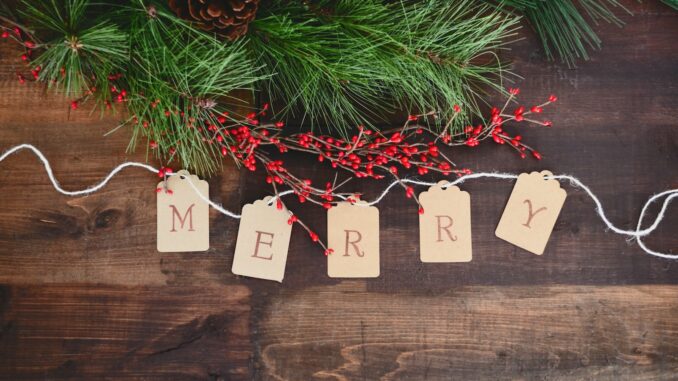 MERRY text cutout on white string by wreath