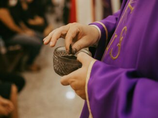 a person in a purple robe holding a cup